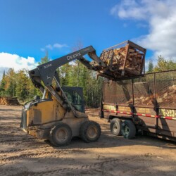 Michigan Fuelwood tractor loading firewood into trailer